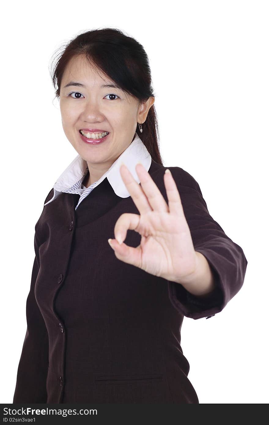 An Asian businesswoman giving the OK sign. An Asian businesswoman giving the OK sign.