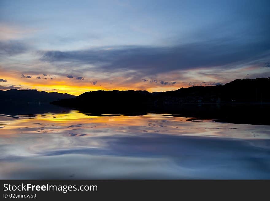 A yellow sunset over the calm sea