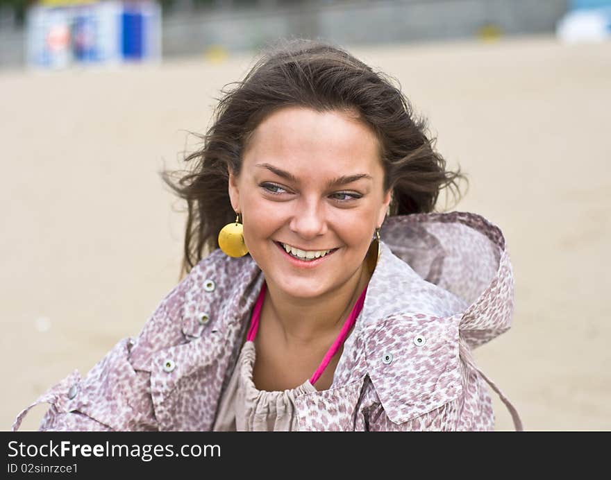 Cute attractive women smiling at the beach. Summer portrait. Blurring background.