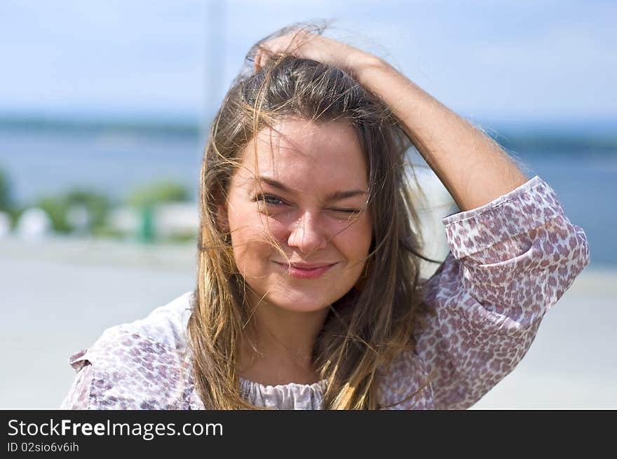 Cute attractive women smiling at the beach. Summer portrait. Blurring background.