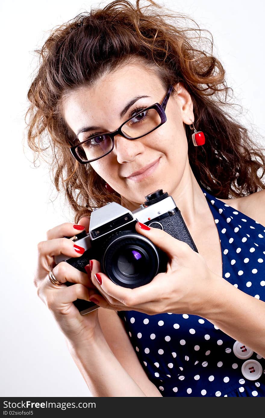 Beautiful woman in a blue polka dot dress with camera