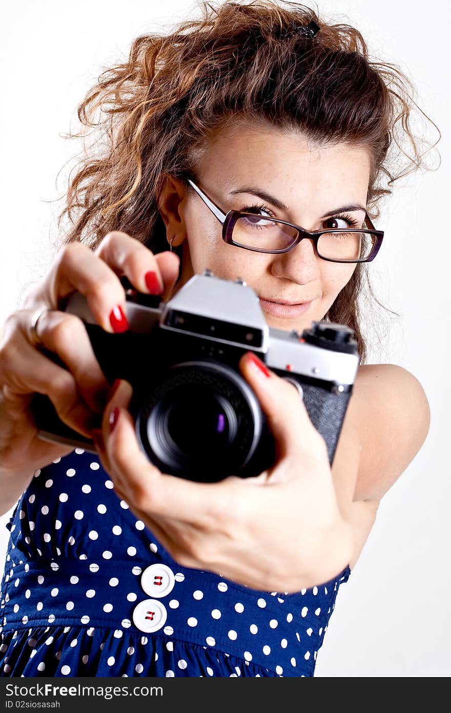 Beautiful woman in a blue polka dot dress with camera