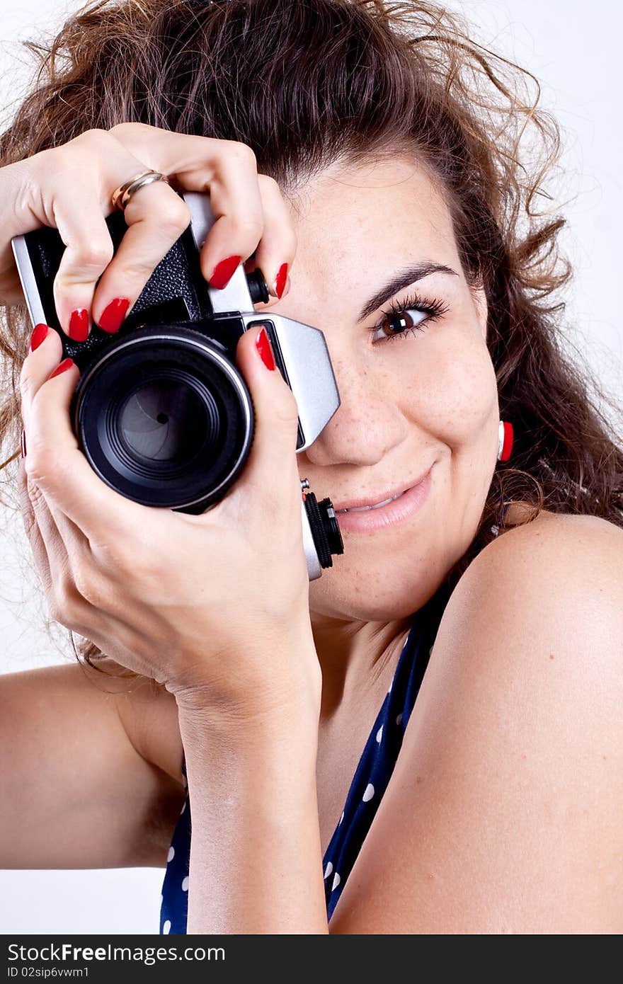 Beautiful woman in a blue polka dot dress with camera