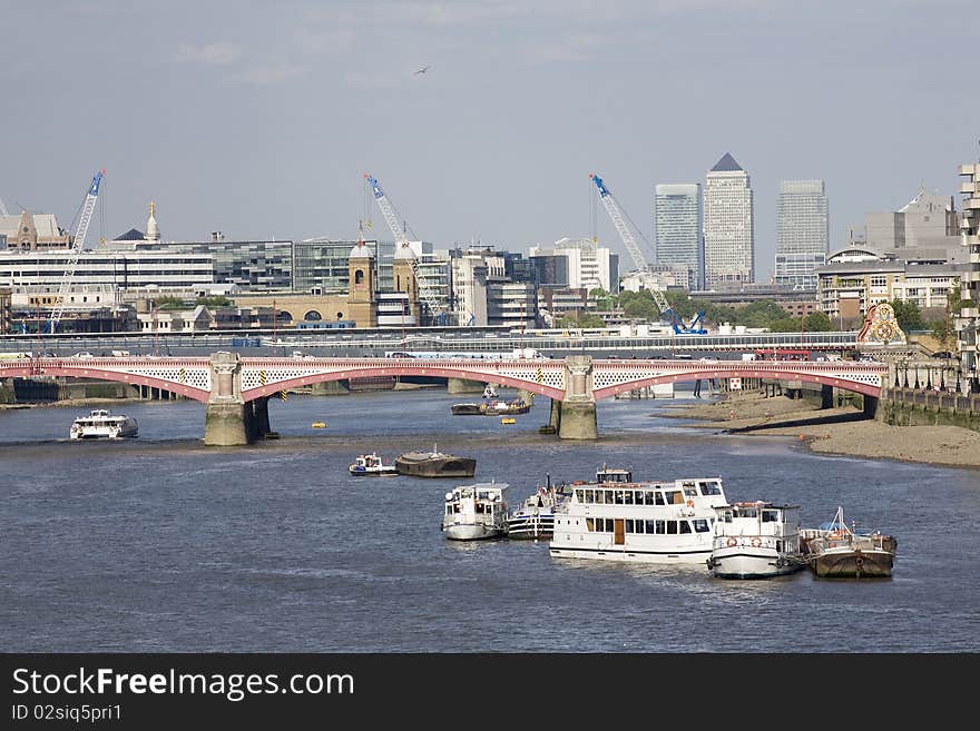 Boats crossing thames river and modern constructions against blue sky in london uk europe. Boats crossing thames river and modern constructions against blue sky in london uk europe