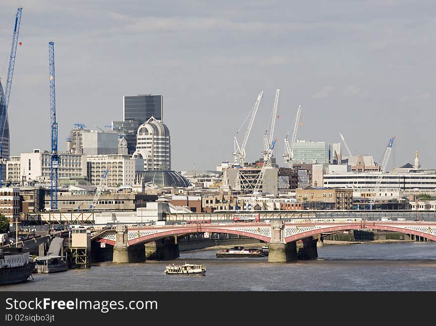 Boats crossing thames river and modern constructions against blue sky in london uk europe. Boats crossing thames river and modern constructions against blue sky in london uk europe