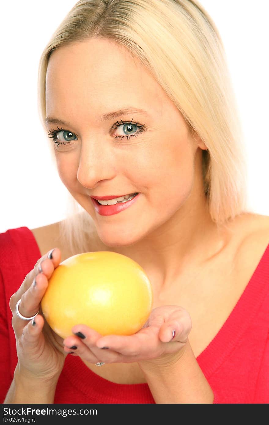 Young blond woman showing a grapefruit. Young blond woman showing a grapefruit