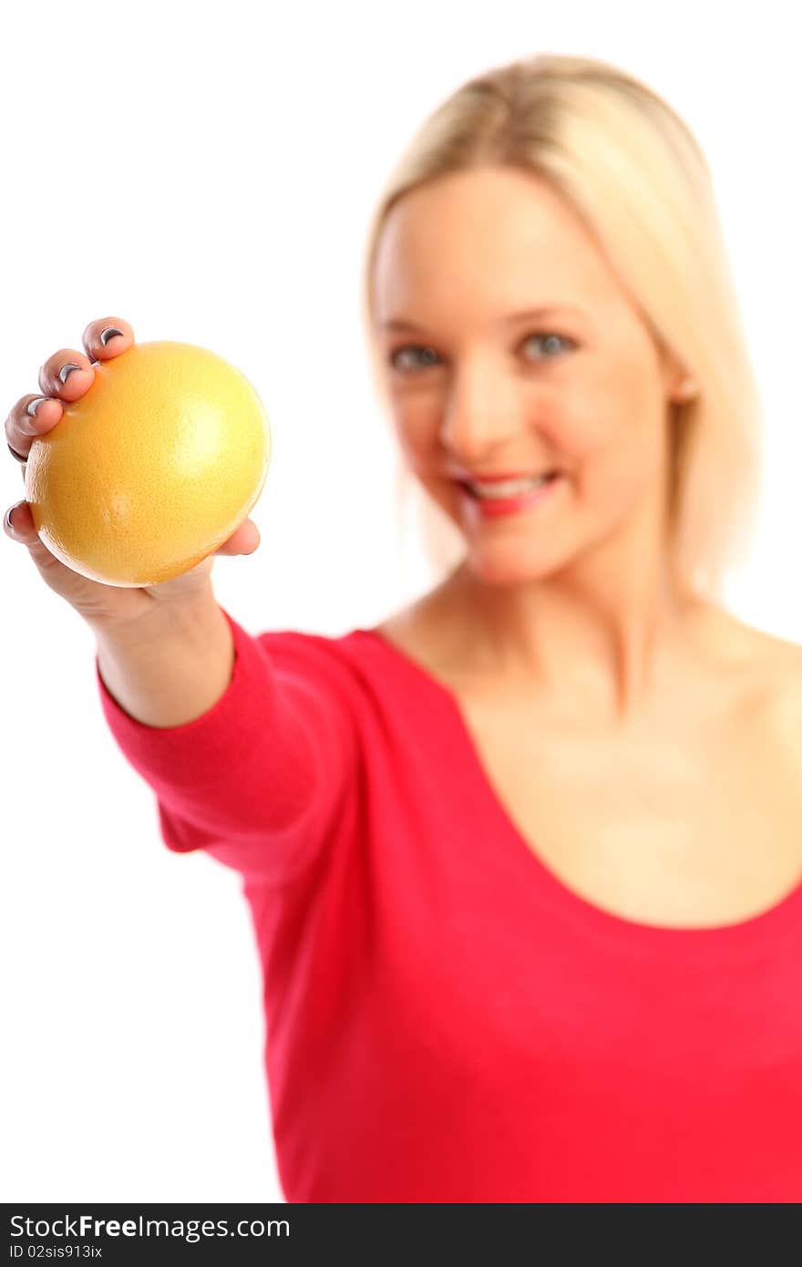 Young blond woman showing a grapefruit. Young blond woman showing a grapefruit