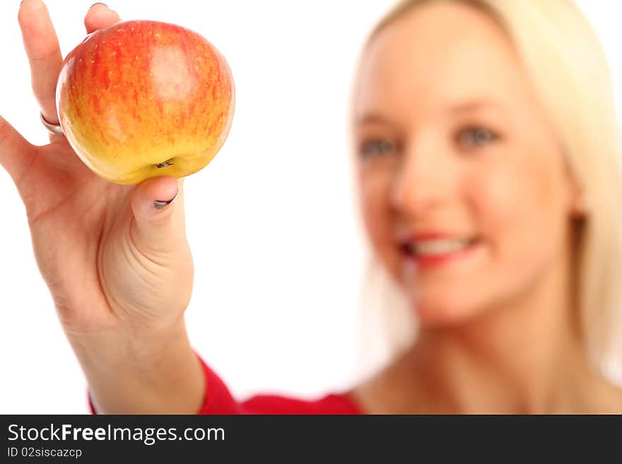 Young blond woman showing a apple. Young blond woman showing a apple