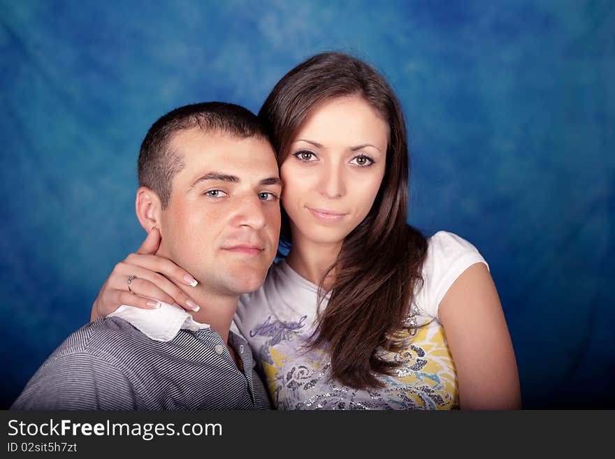 Woman and man posing together on a blue background. Woman and man posing together on a blue background