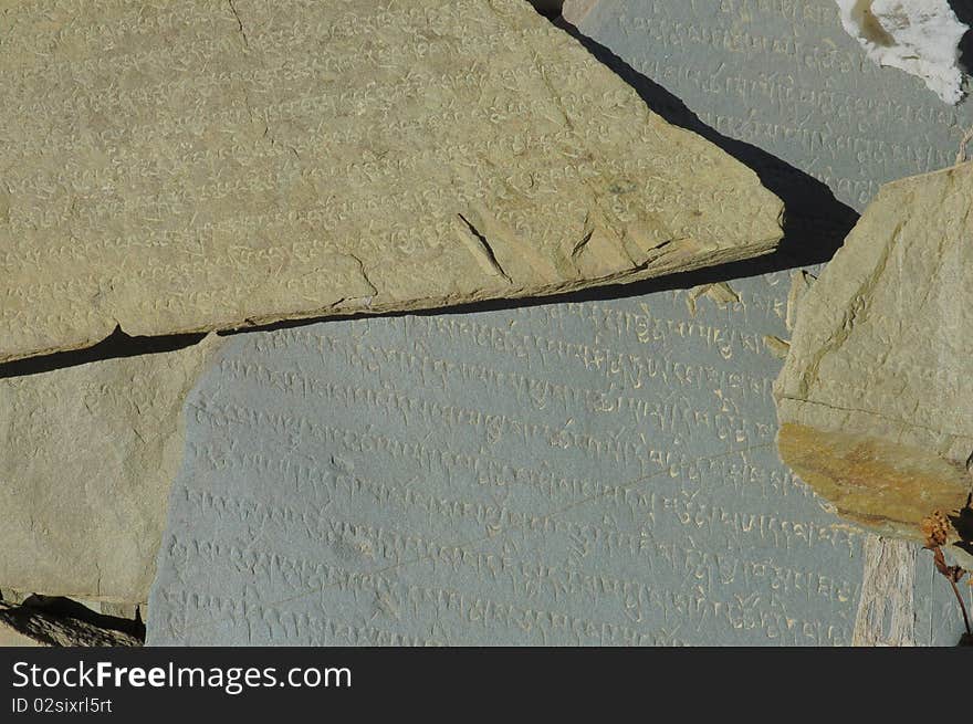 Buddhist scriptures close-up on mani stone.Tibet.