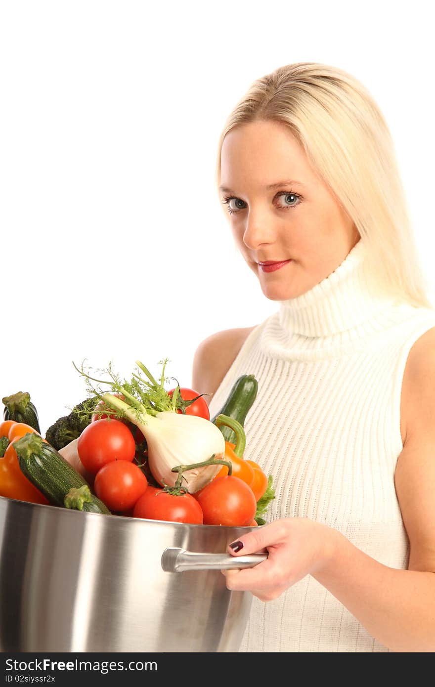 Young blond woman holding some different fresh vegetables. Young blond woman holding some different fresh vegetables