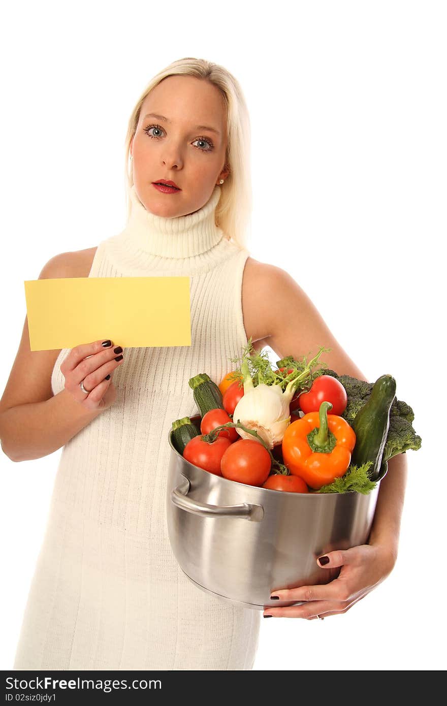 Young blond woman holding some different fresh vegetables and a yellow sign. Young blond woman holding some different fresh vegetables and a yellow sign