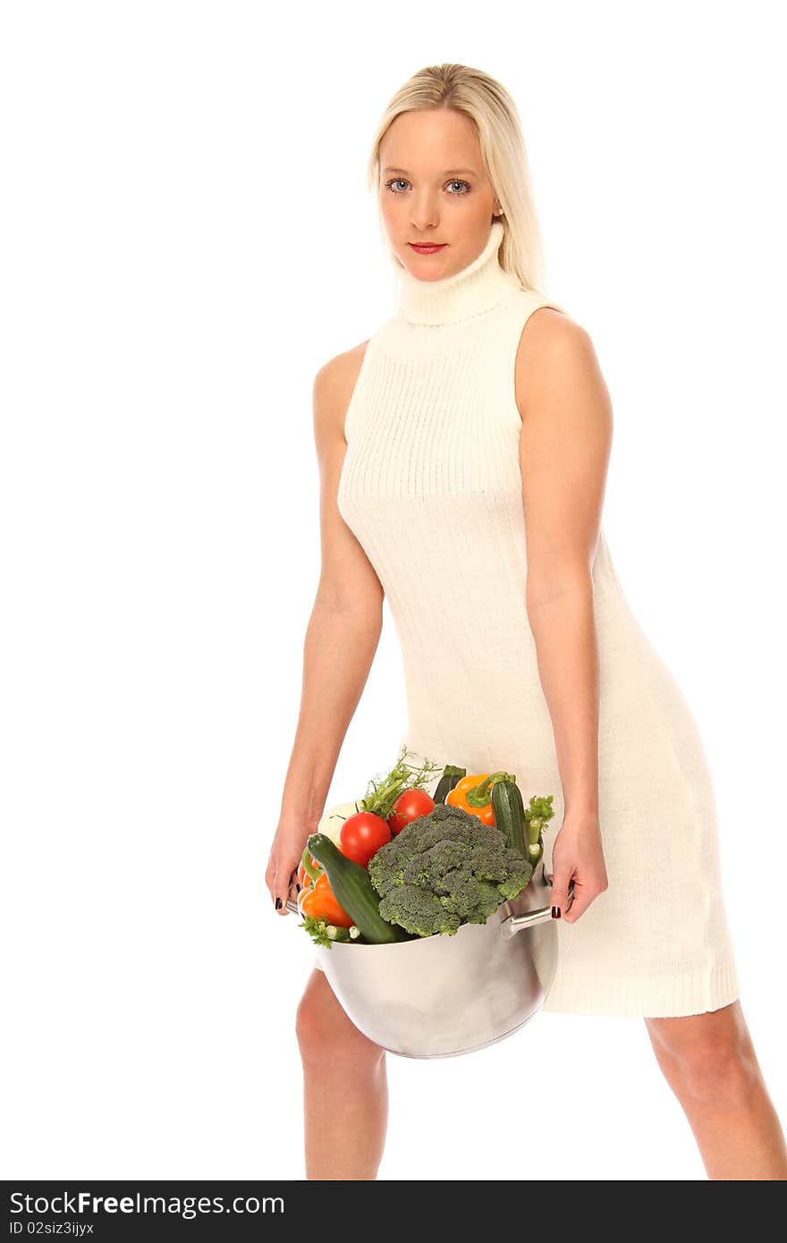 Young blond woman holding some different fresh vegetables. Young blond woman holding some different fresh vegetables