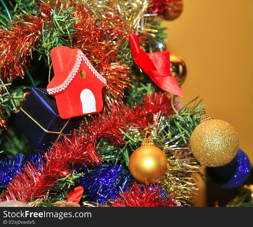 Shiny christmas tree decorations in gold, red, blue. Shiny christmas tree decorations in gold, red, blue