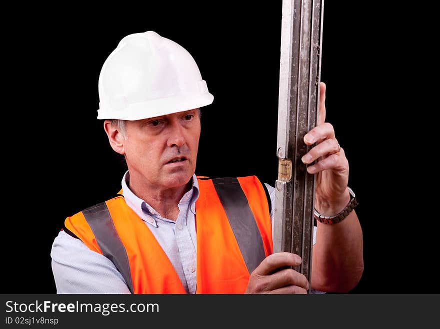 An engineer examining a spirit level. An engineer examining a spirit level