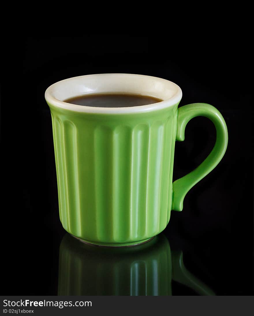 Green coffee cup on black background