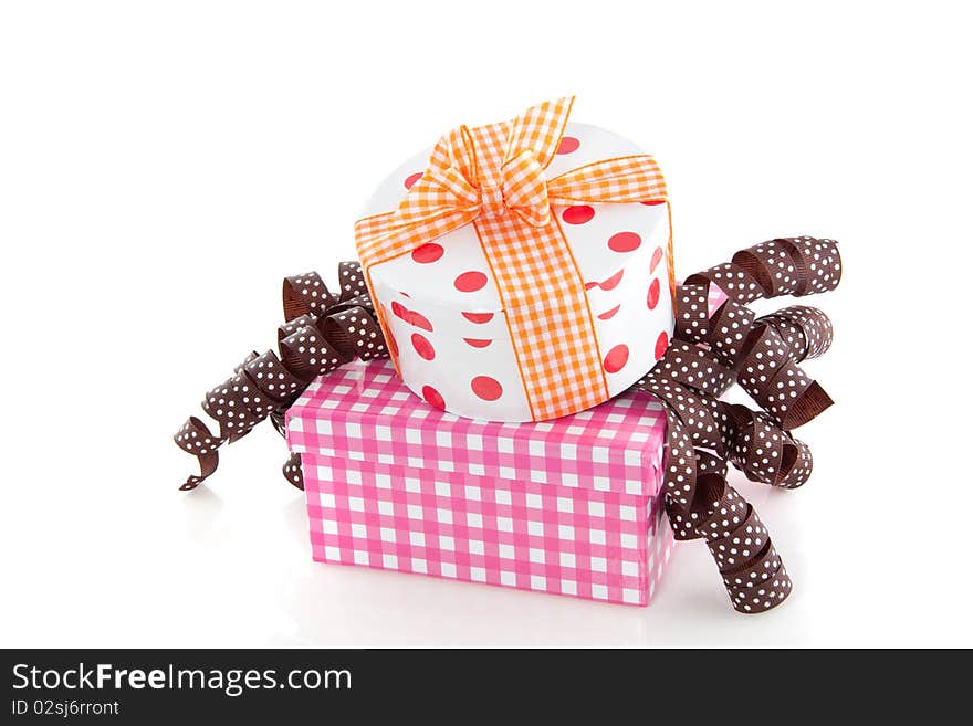 Colorful dotted and checkered giftboxes with ribbons isolated over white. Colorful dotted and checkered giftboxes with ribbons isolated over white