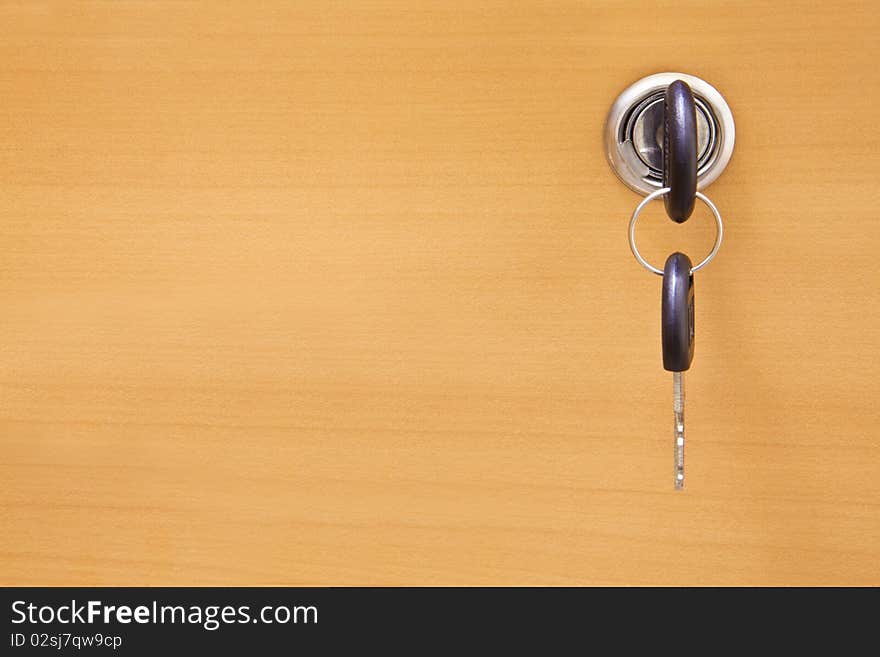 Wooden door and keys in a keyhole