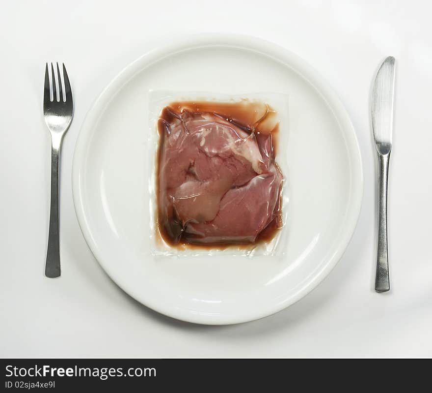 Vacuum packed meat on a plate. Vacuum packed meat on a plate