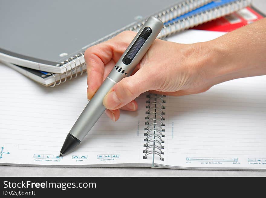 Ready to take notes with pen to paper in this pic of hand holding pen on notebooks. Ready to take notes with pen to paper in this pic of hand holding pen on notebooks