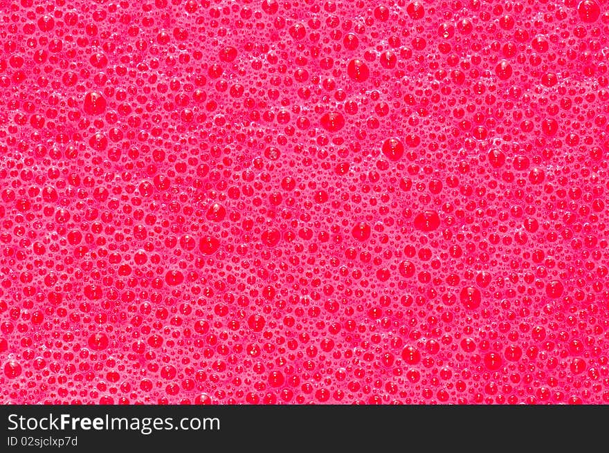 Bubbles formed in freshly mixed red dye. Bubbles formed in freshly mixed red dye