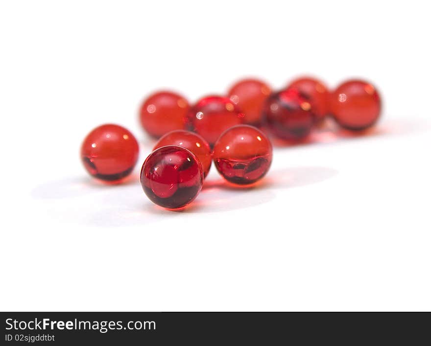 Few red vitamins isolated on white background