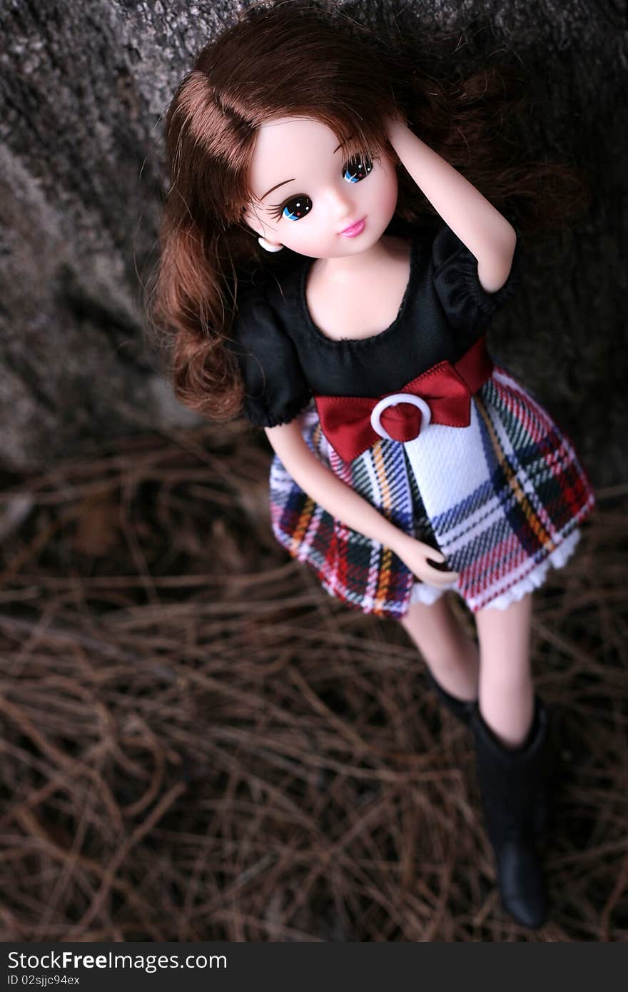 Doll Standing Besides The Tree