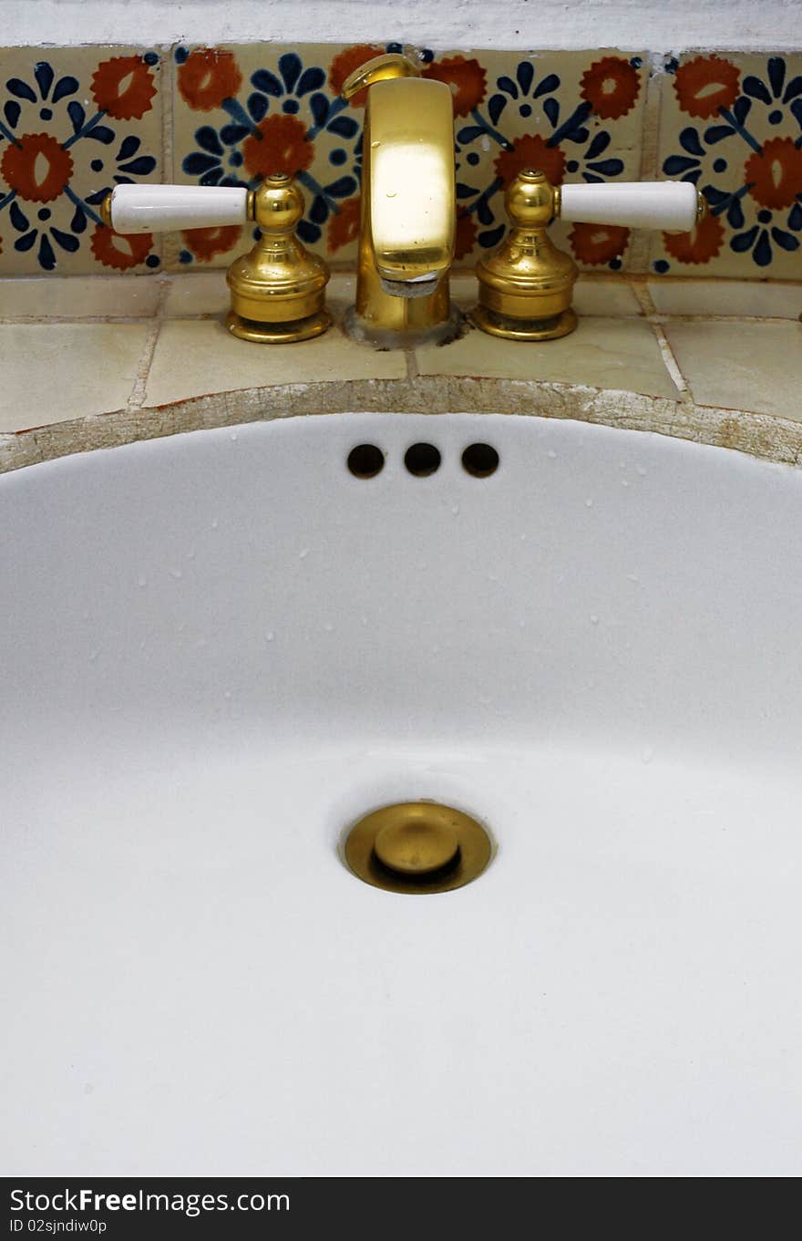 Detail of luxury sink with gold tap in hotel room. Detail of luxury sink with gold tap in hotel room