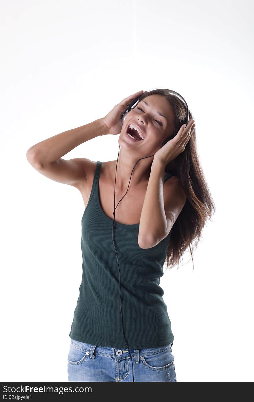 Beautiful teenage girl listening to muscic and singing. Beautiful teenage girl listening to muscic and singing