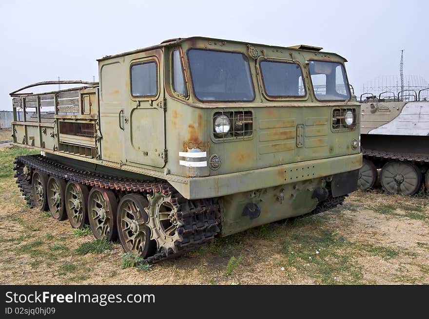 Old Army heavy all-terrain vehicle on tracks. Used to move goods and foot.