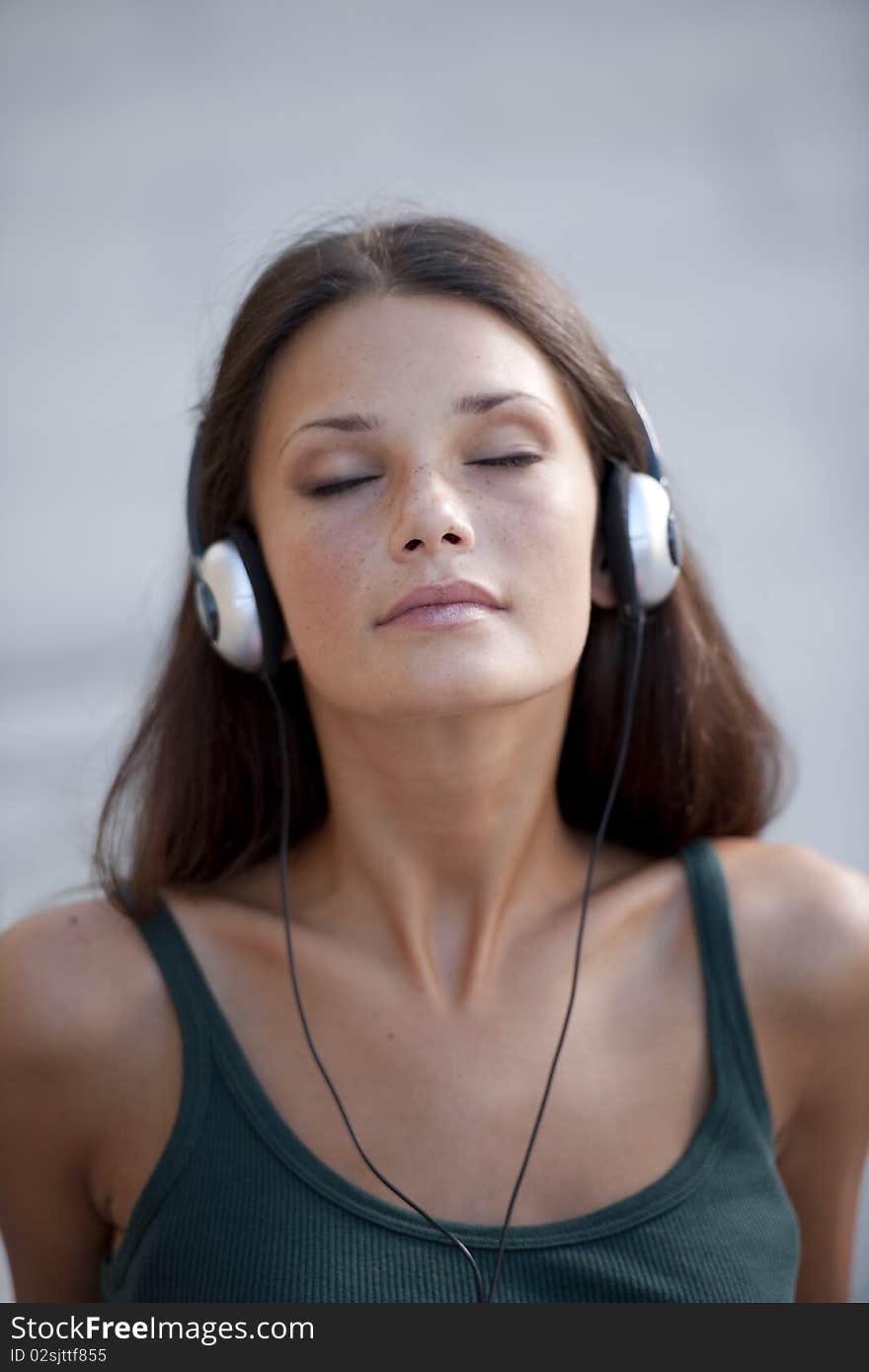 Beautiful teenage girl listening to muscic and relaxing. Beautiful teenage girl listening to muscic and relaxing