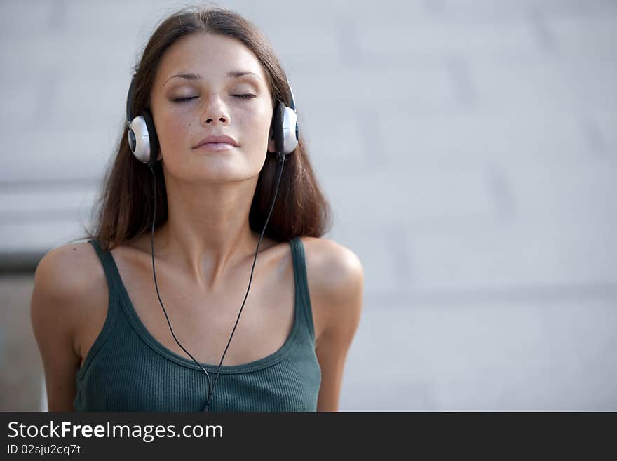 Beautiful teenage girl listening to muscic and relaxing. Beautiful teenage girl listening to muscic and relaxing