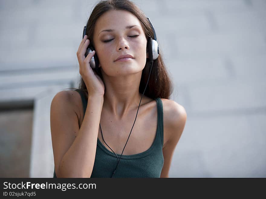 Beautiful teenage girl listening to muscic and relaxing. Beautiful teenage girl listening to muscic and relaxing