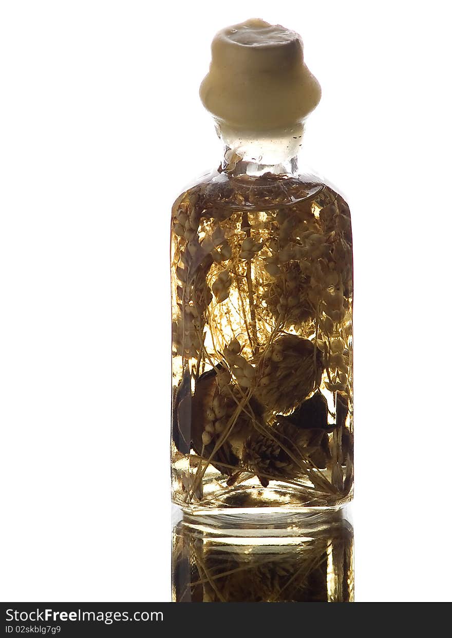 The photo shows a small bottle filled with bathoil over a mirror