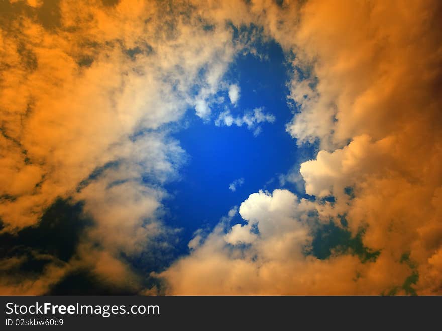 Puffy Clouds With Orange Overlay