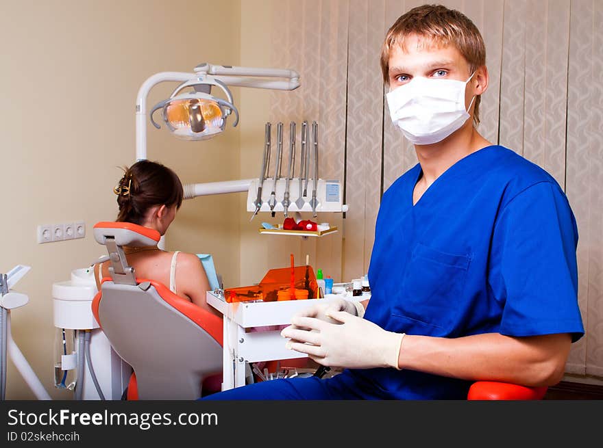 Young dentist in his office looking at the viewer. Young dentist in his office looking at the viewer