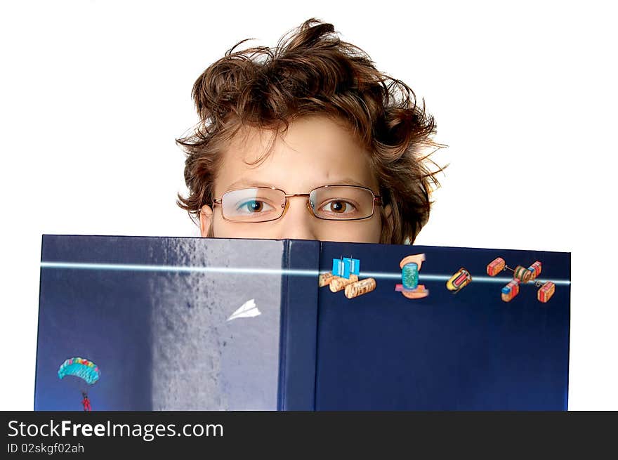 Cute little boy with a big book on white background