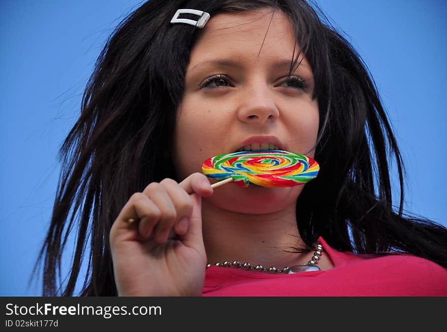 Girl with lollipop and blue sky