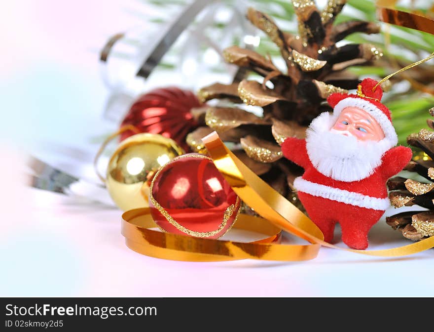 Christmas ornaments and Santa near the Christmas tree and cones. Christmas ornaments and Santa near the Christmas tree and cones