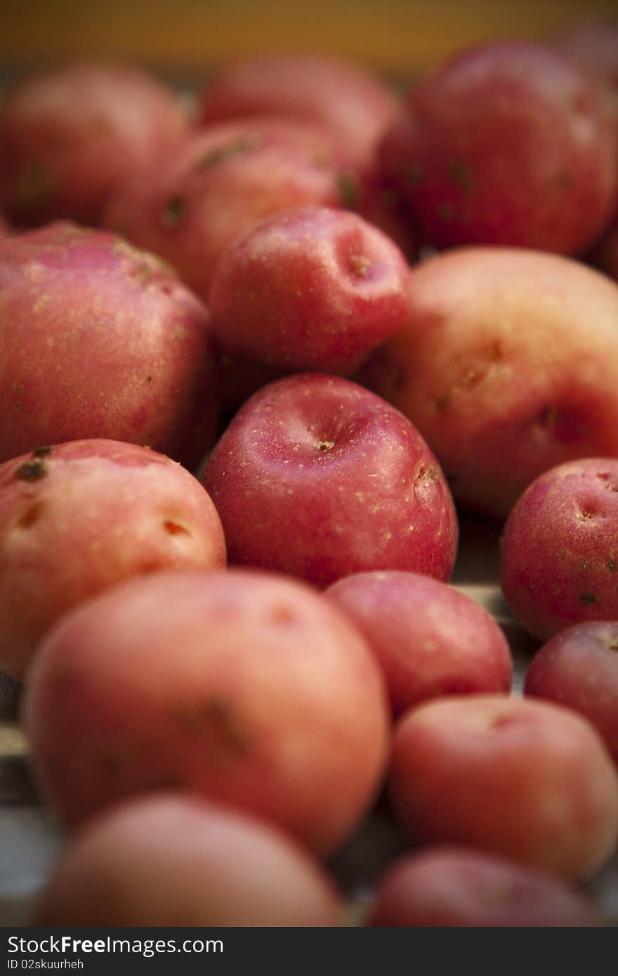 Red potatoes on table with blur