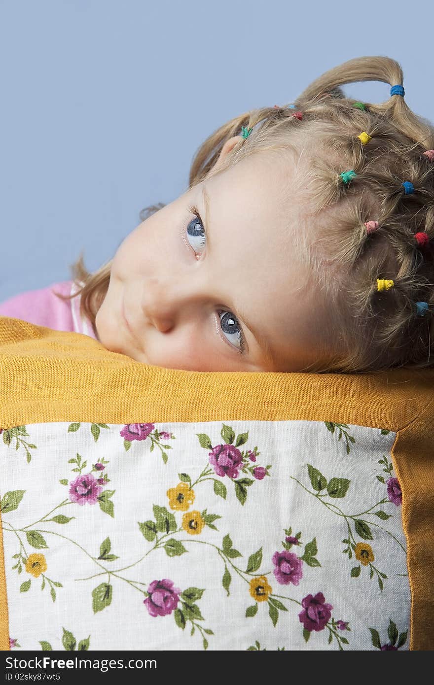 Cute caucasian blond little girl preparing to go to sleep having her decorated pillow near and looking appear with calm look isolated. Cute caucasian blond little girl preparing to go to sleep having her decorated pillow near and looking appear with calm look isolated