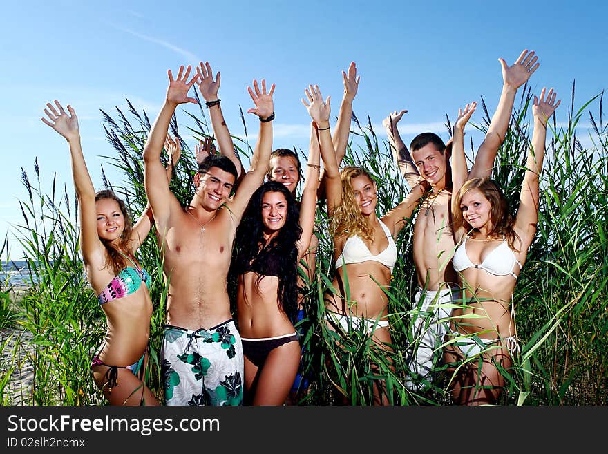 Happy teenagers playing in the sea