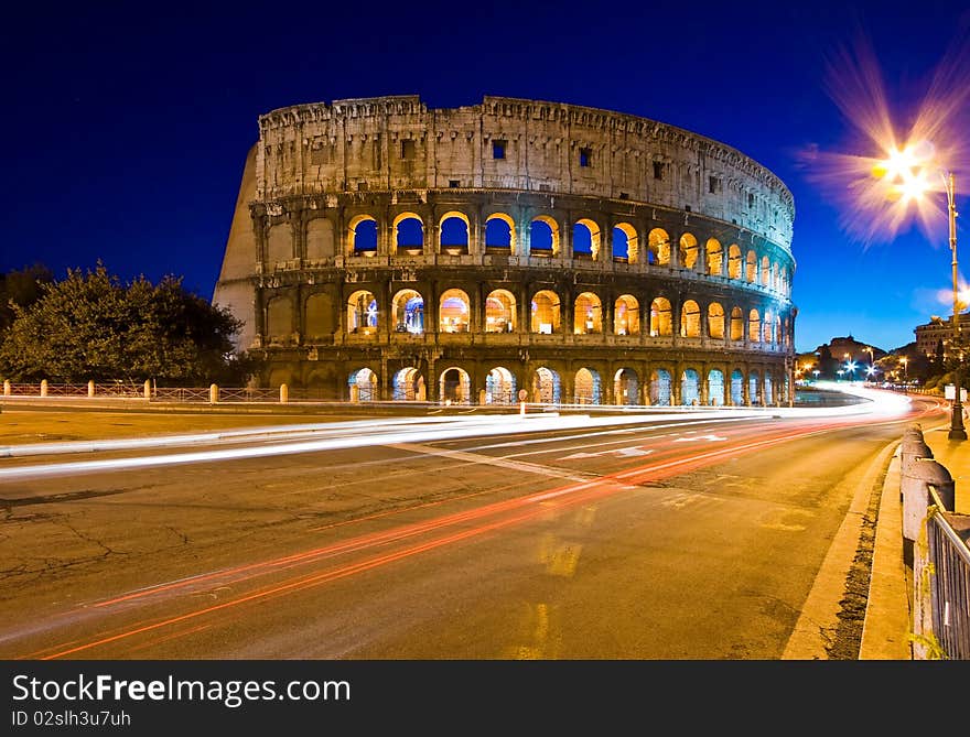 Colosseum In Twilight With Light Trail