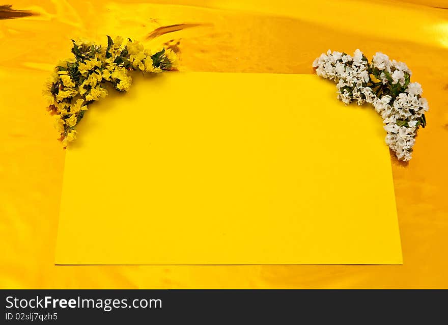 Yellow greeting card with flowers on yellow background