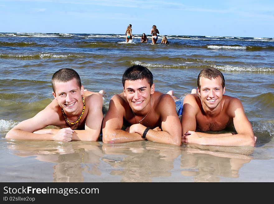 Happy teenagers playing at the sea