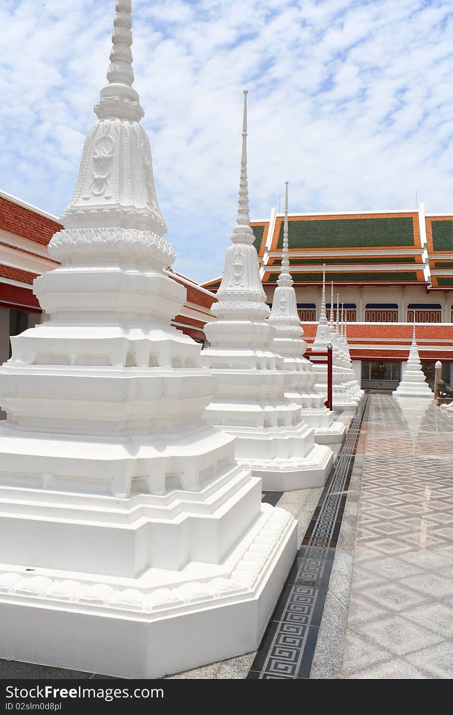 White pagoda in thai temple and refliction on ground