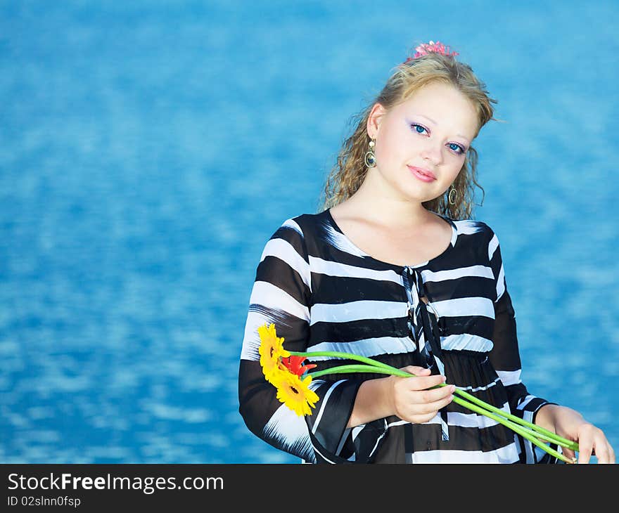 Beautiful woman with flowers in the sea. Beautiful woman with flowers in the sea