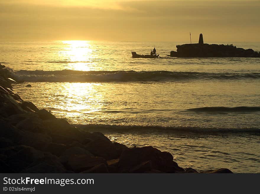 Silhouette of a fishing boat leaving Elmina harbour in Ghana. Silhouette of a fishing boat leaving Elmina harbour in Ghana