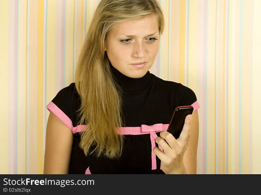 Young girl reading a SMS. His face expressed surprise. Young girl reading a SMS. His face expressed surprise