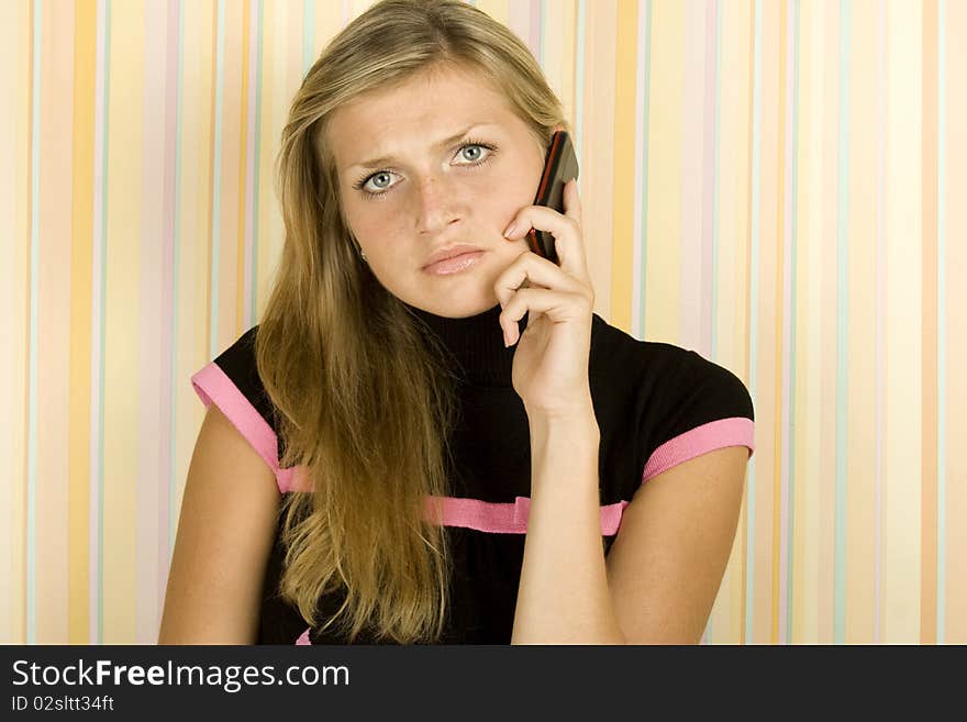 Young woman in the room talking on the phone. Surprise. Young woman in the room talking on the phone. Surprise